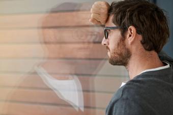 Libra man reflecting in window