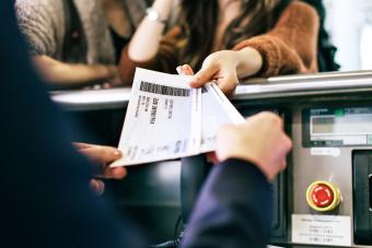 Travellers Getting Boarding Passes At Check-In 