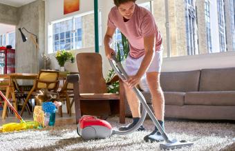 man doing housework vacuuming