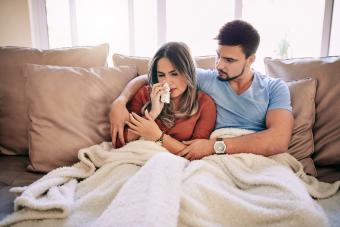 Man taking care of sick girlfriend