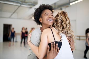 Dance instructor and student hugging