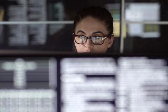 Data woman surrounded by monitors 