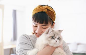 woman hugging her cat