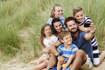 Family taking a selfie on beach sand dune