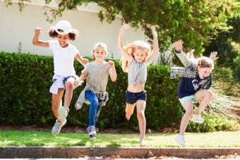 kids jumping outdoors on a summer day