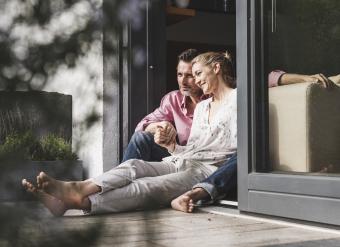 couple spending time together sitting on patio of home