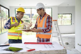 construction engineers studying a house mockup