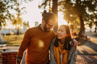 Young woman and young man ride skateboard