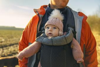 baby girl in carrier hiking with father