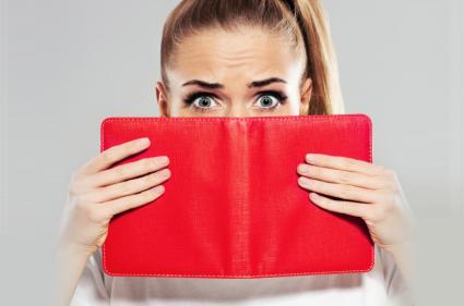 Woman covering face with book