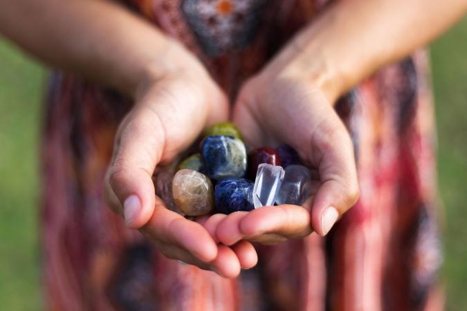 Woman holding handful of gemstones