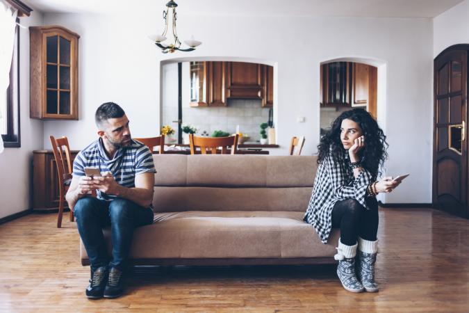 Couple on opposite ends of sofa