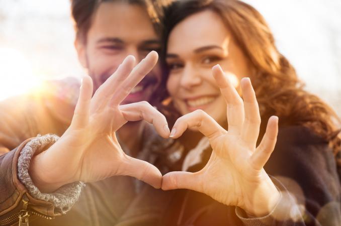 Couple making heart hands