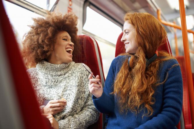 Two women talking on a train