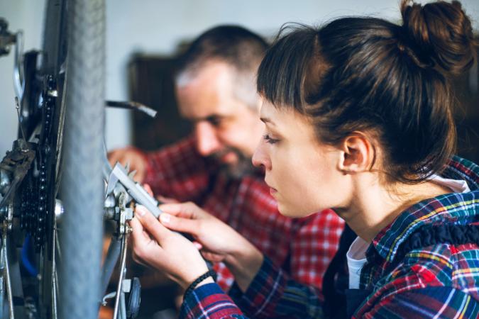 Couple repairing bicycle