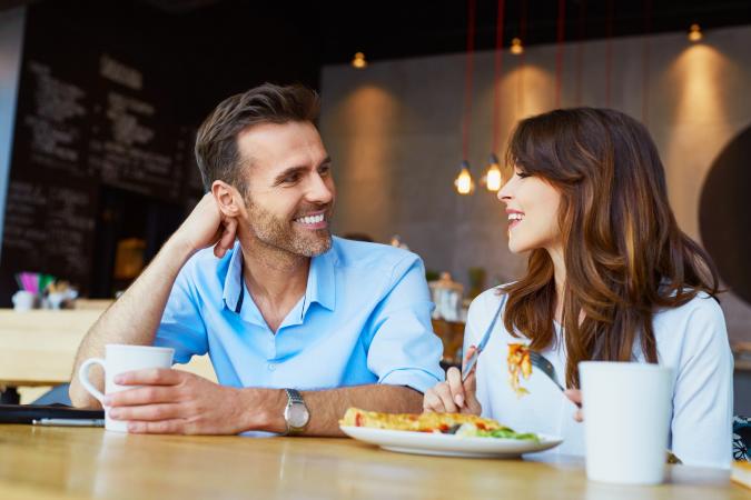Couple at cafe talking during lunch