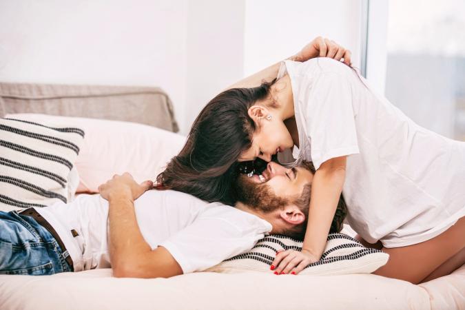 Happy couple man and woman at home in bedroom