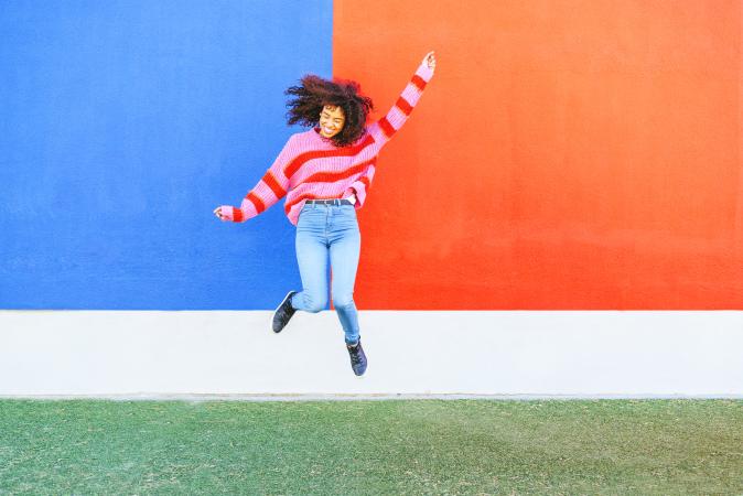 Happy young woman jumping in the air