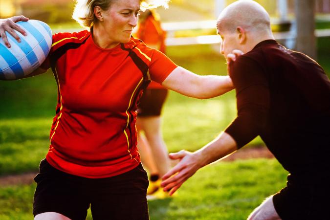 Woman rugby player holding ball