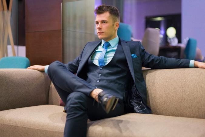 Stylish man sitting on sofa