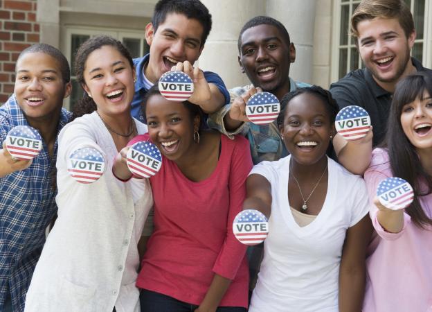 Group of people holding Vote buttons