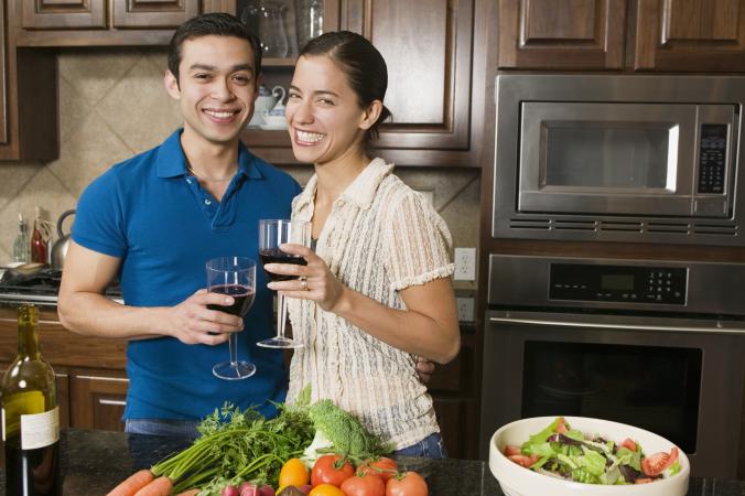 Couple drinking wine while cooking dinner