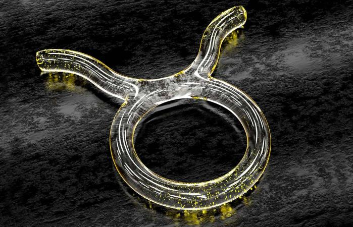 Astrology symbol in glass with yellow particles