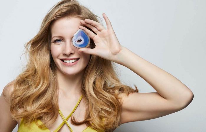 woman holding a blue agate gemstone