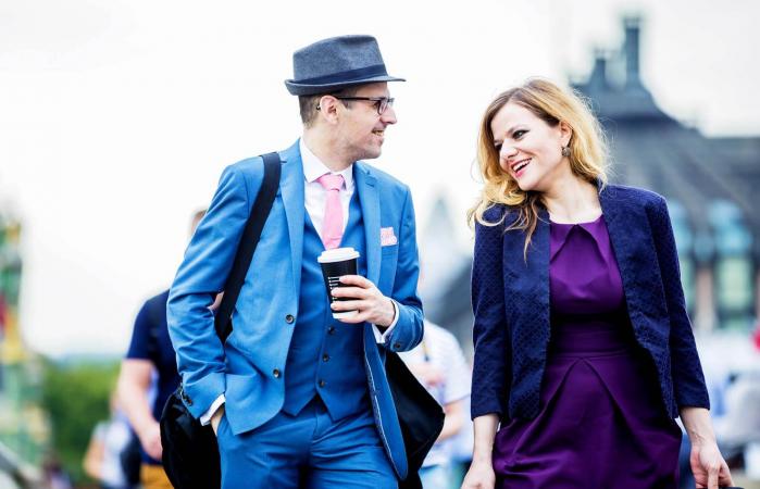 man and woman talking on street