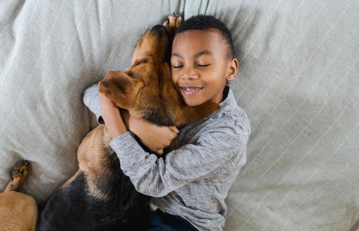 Boy hugging adopted dog