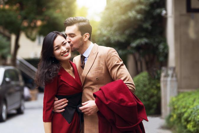 Handsome young couple, walking down the street in formal elegant clothes