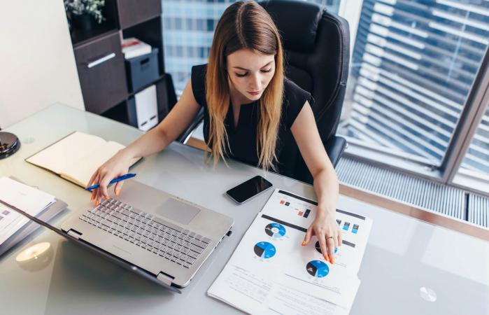 Businesswoman reading financial report