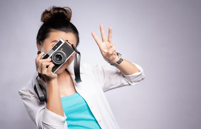Woman gesturing while photographing