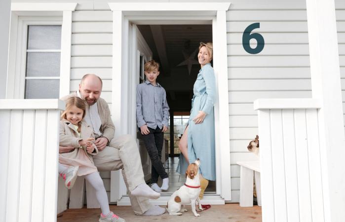 family on porch of their house