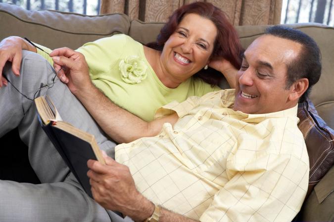 Pareja madura en el sofá leyendo