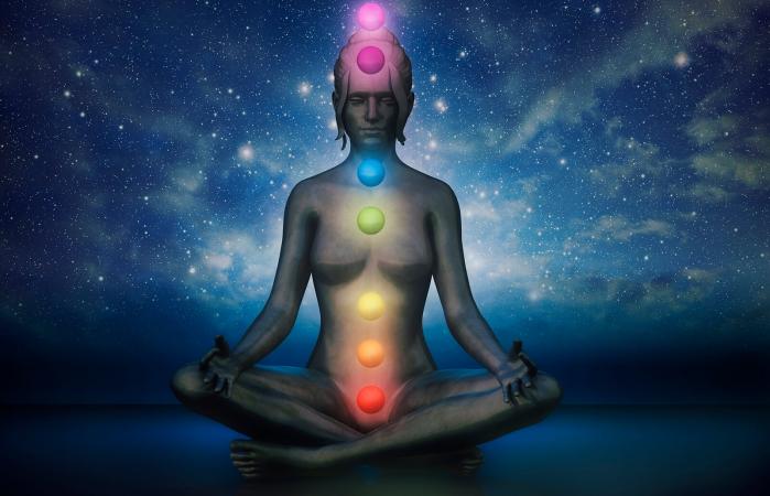 Posición de loto meditación con chakras visibles