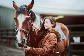 teenage girl standing next to her pon