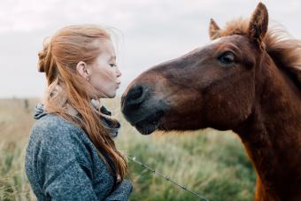 Woman kissing her horse