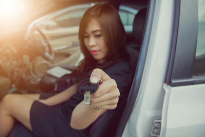 Woman handing over car key