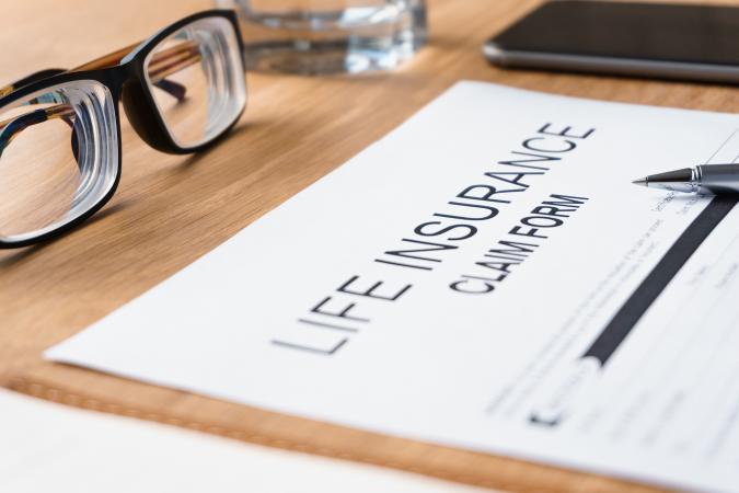Life Insurance claim form on table