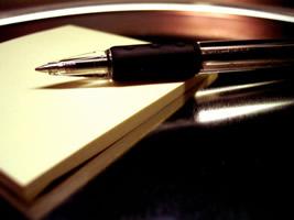 A pen atop a scratch-paper pad