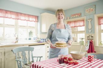 Woman holding birthday cake in Americana kitchen