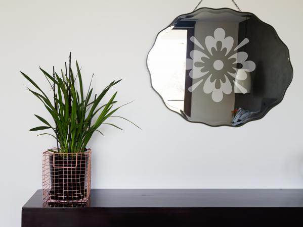 Engraved mirror hanging on wall
