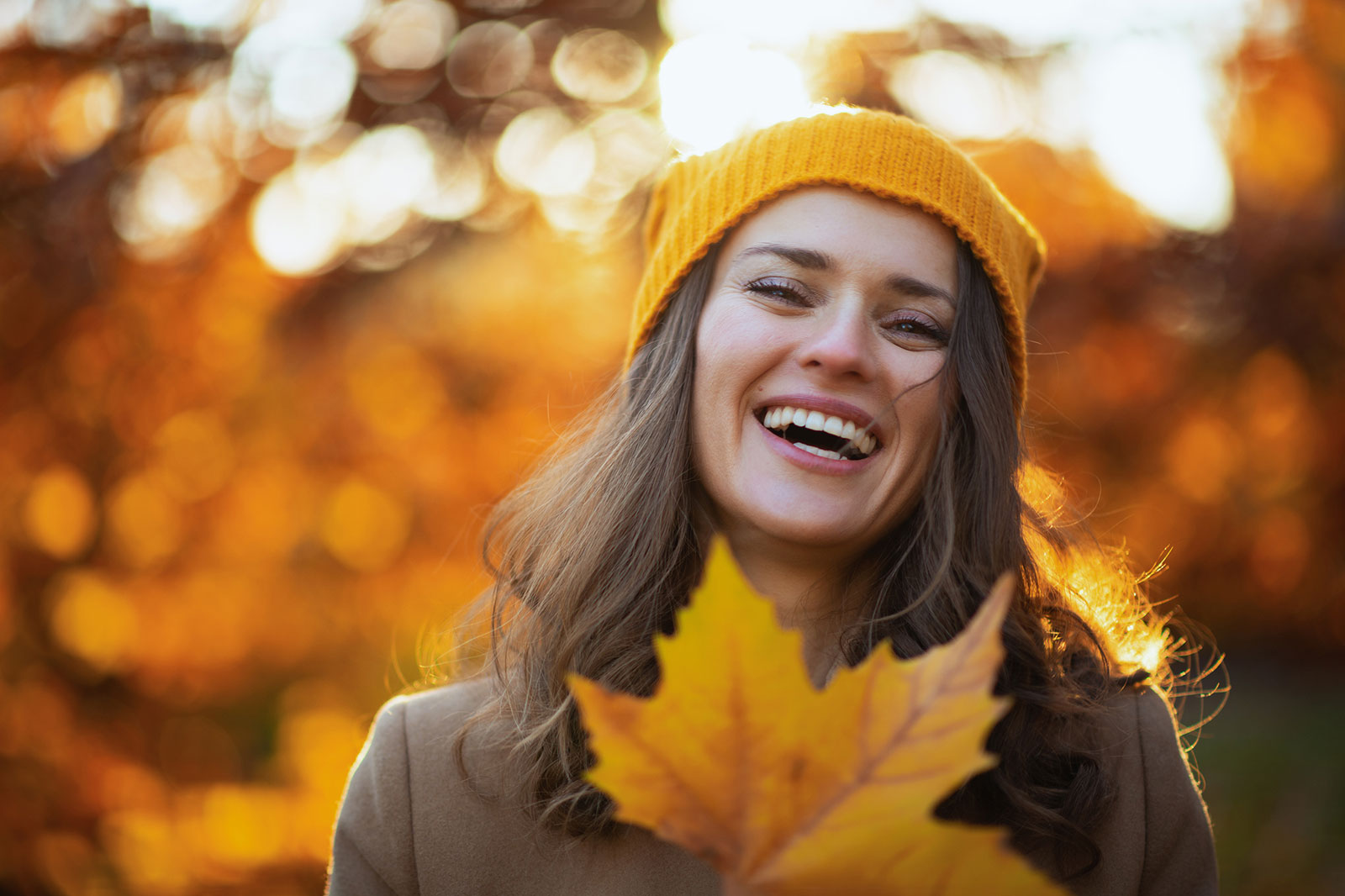 woman-smiling-autumn-leaves.jpg