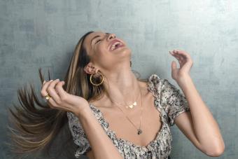 Cheerful woman tossing hair