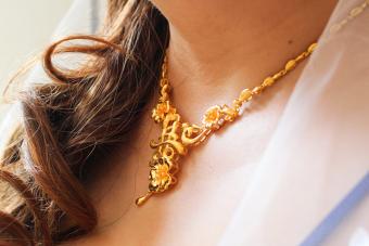 Woman Wearing Gold Necklace