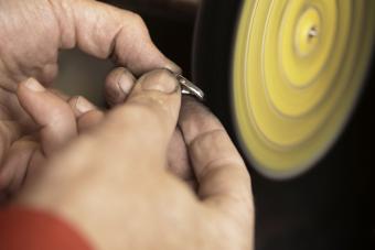 A jeweler polishes a customers white gold ring