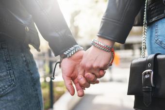 Young loving couple holding hands