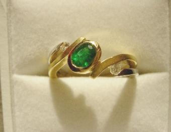 Photo of an Emerald ring in a jewelry box