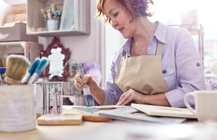 female artist painting picture frames